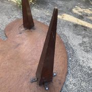 Mid-century coffee table with a palette shape and splayed legs.