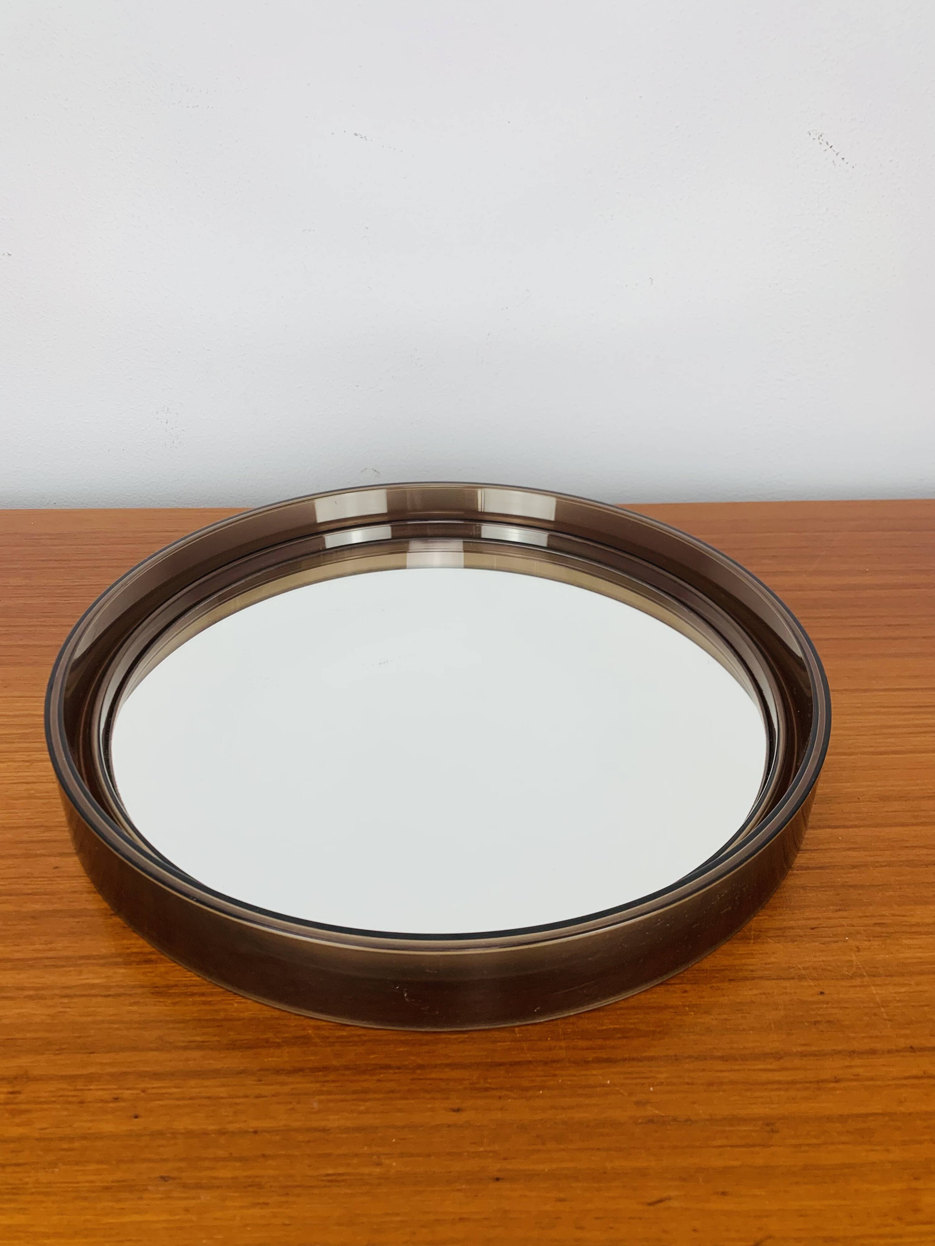Round mirror with amber rim from the 70s, vintage