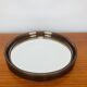 Round mirror with amber rim from the 70s, vintage