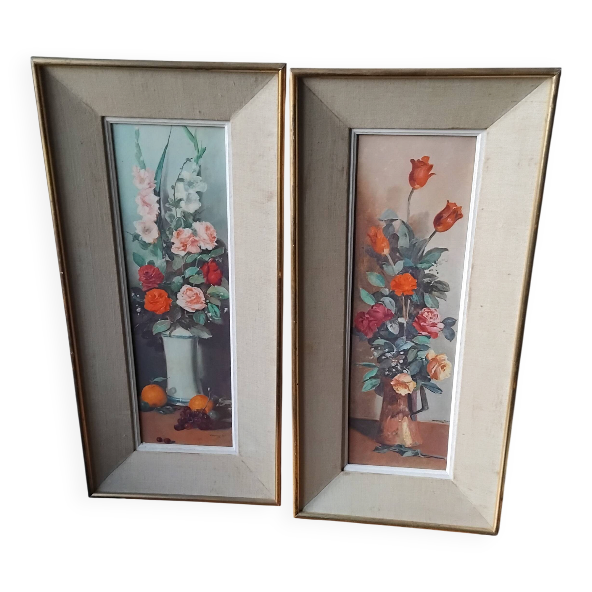 Pair of framed paintings featuring a composition of flowers.
