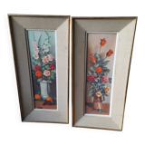 Pair of framed paintings featuring a composition of flowers.
