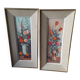 Pair of framed paintings featuring a composition of flowers.