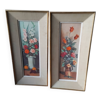 Pair of framed paintings featuring a composition of flowers.