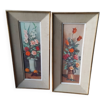 Pair of framed paintings featuring a composition of flowers.