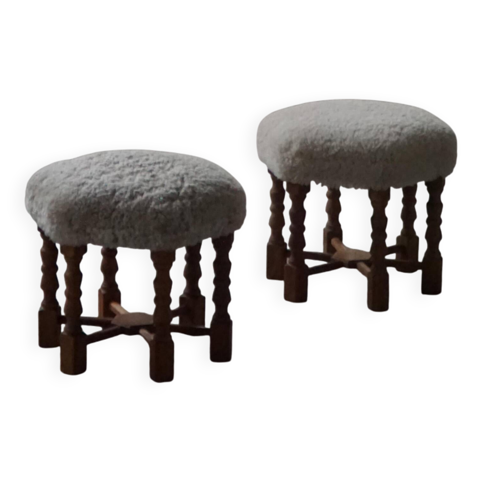 Pair of mid-century Danish oak stools with shearling lambswool upholstery, 1950s.