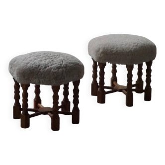 Pair of mid-century Danish oak stools with shearling lambswool upholstery, 1950s.