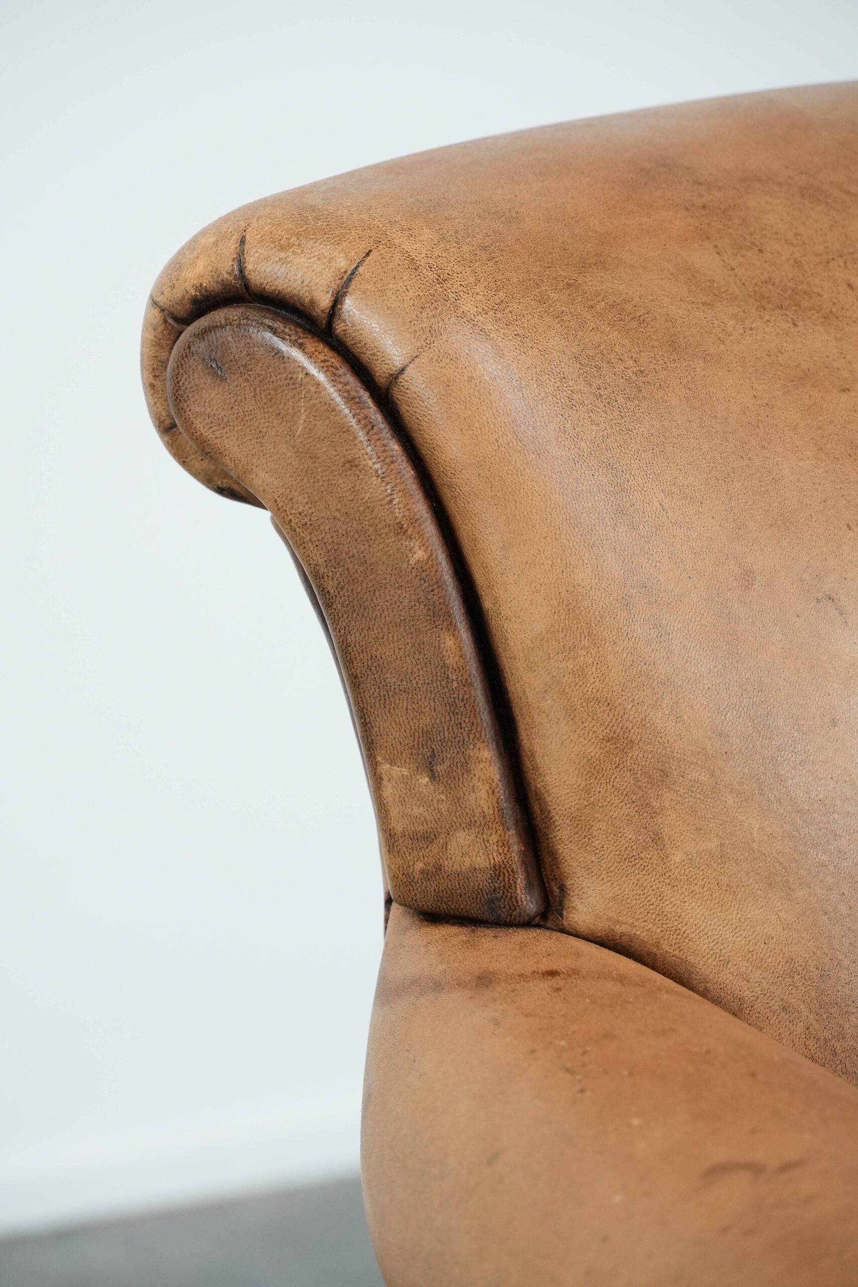 Vintage sheepskin armchair with a beautiful light colour and elegant legs