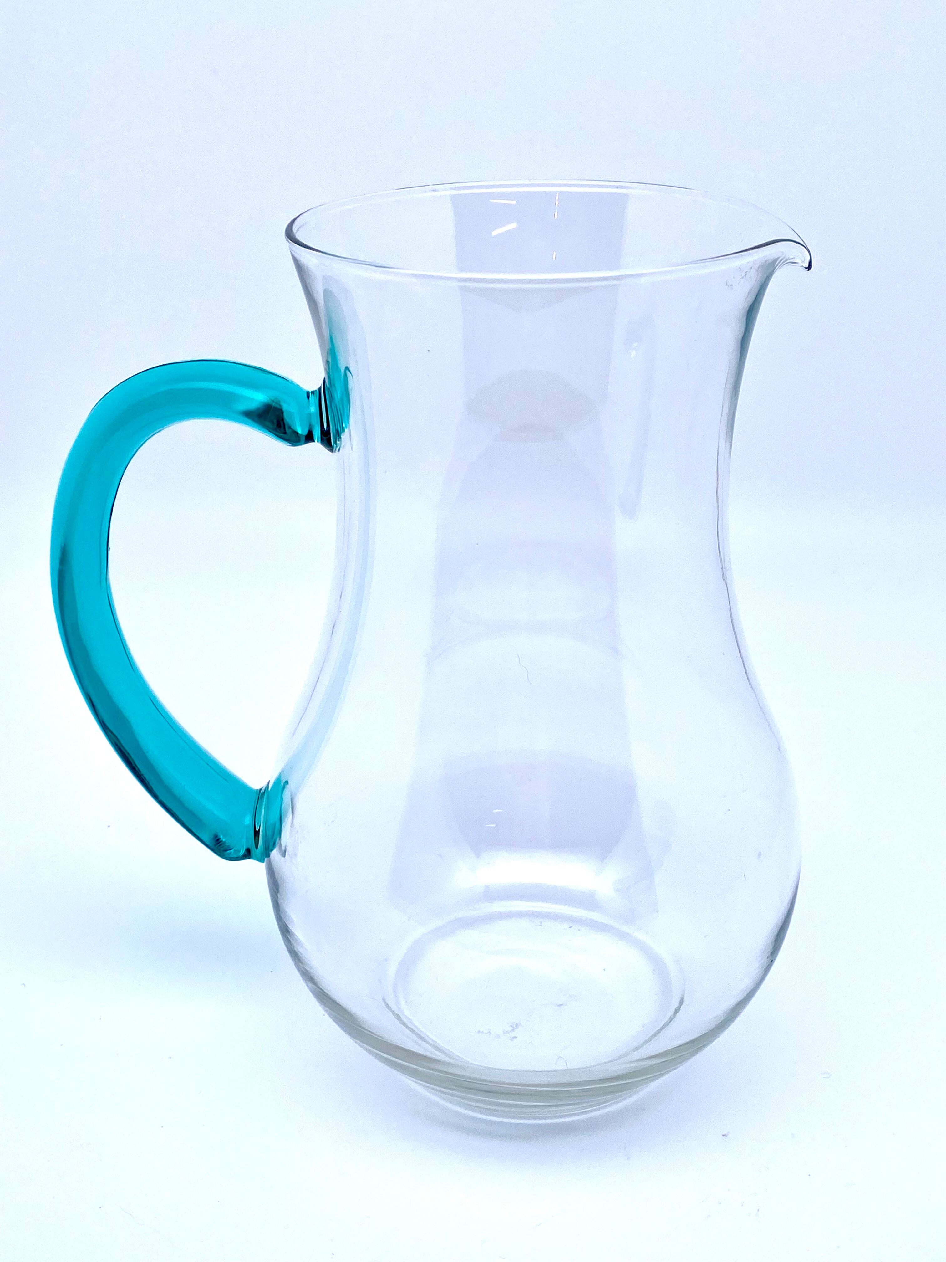 Transparent glass decanter and green handle