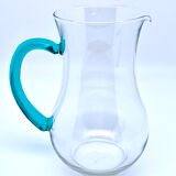 Transparent glass decanter and green handle