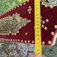 Large oriental mirror with embossed brass decoration on a red velvet background