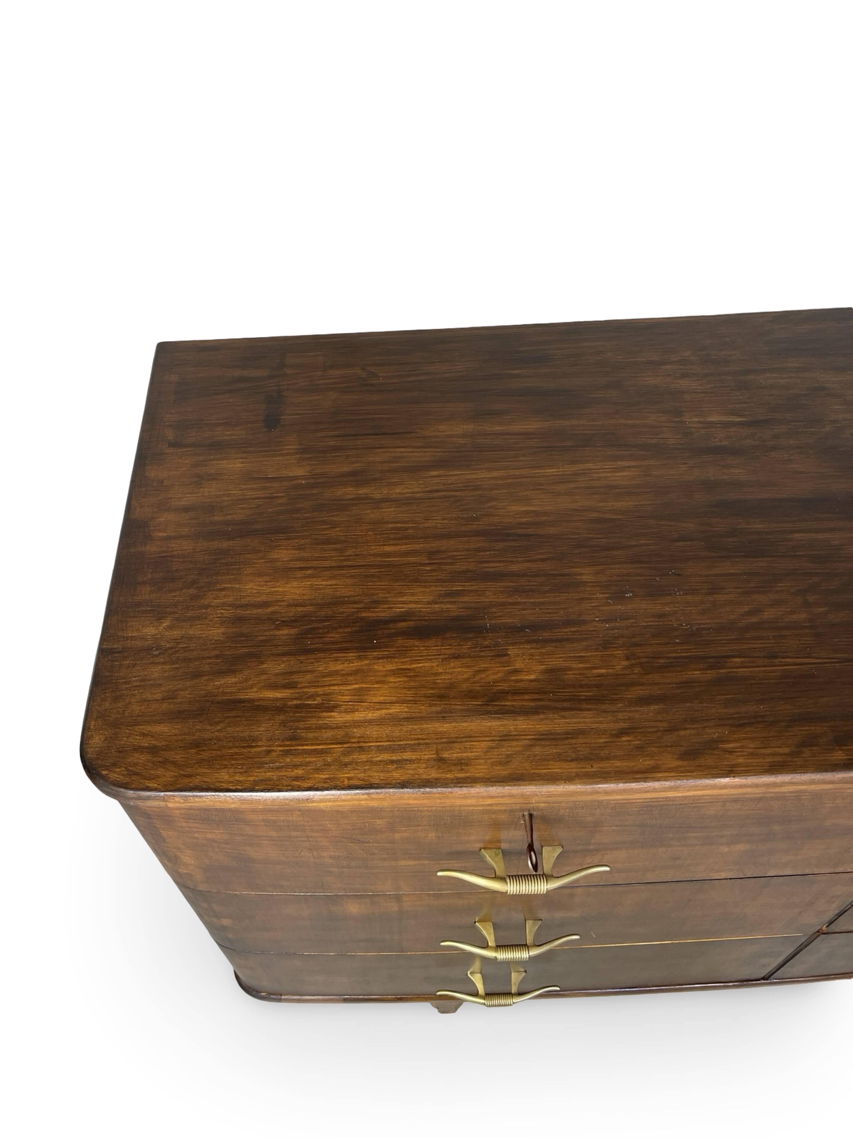 A vintage Italian chest of drawers, made of veneered walnut and solid wood,