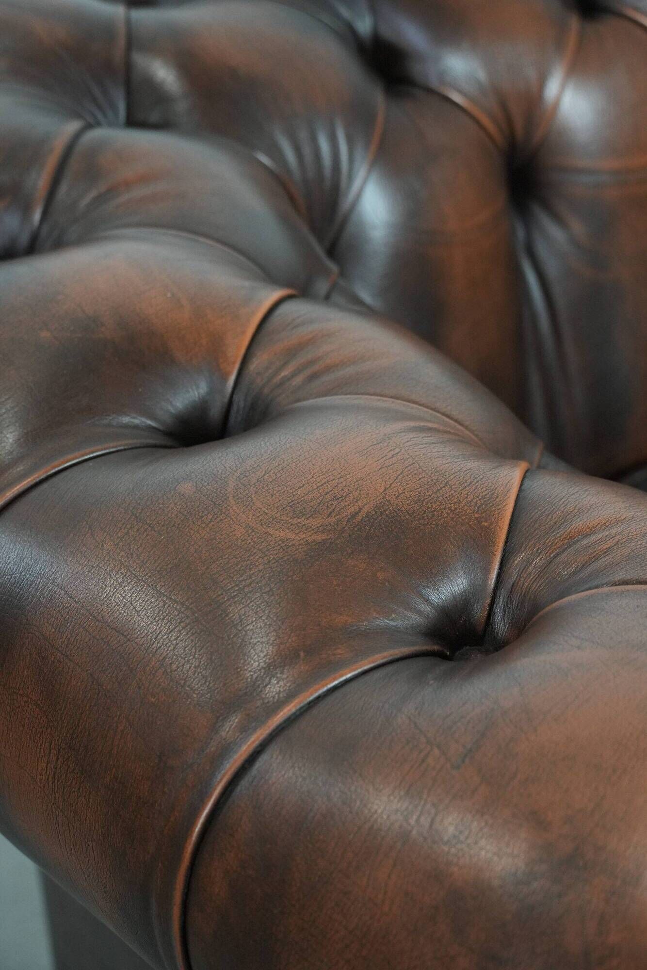 Brown Chesterfield armchair made of cowhide leather in English style