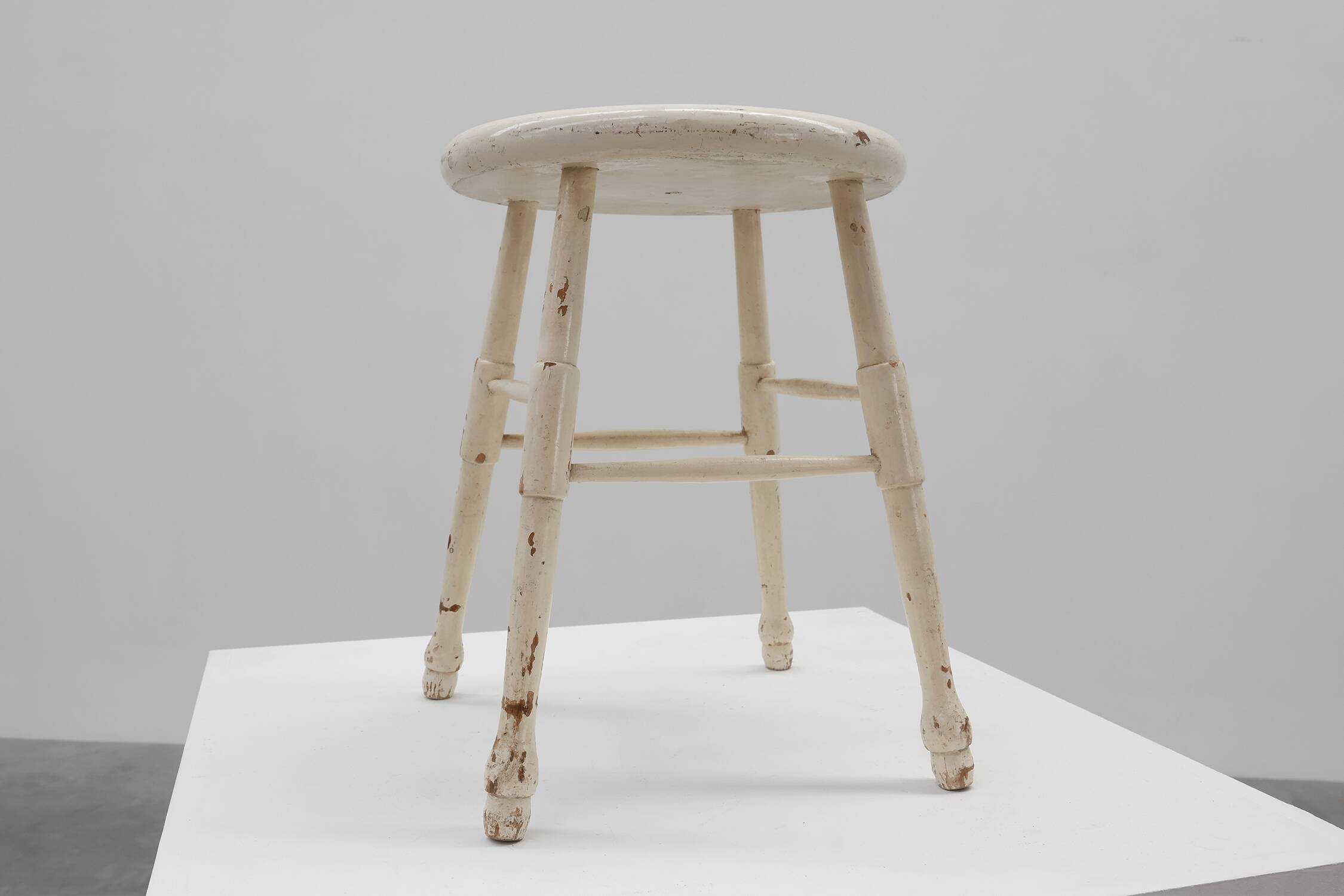 Rustic white wooden low farm stool, France ca. 1920