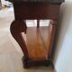 Empire/Restoration style console table with scrolled ends, mirrored back, and claw feet.