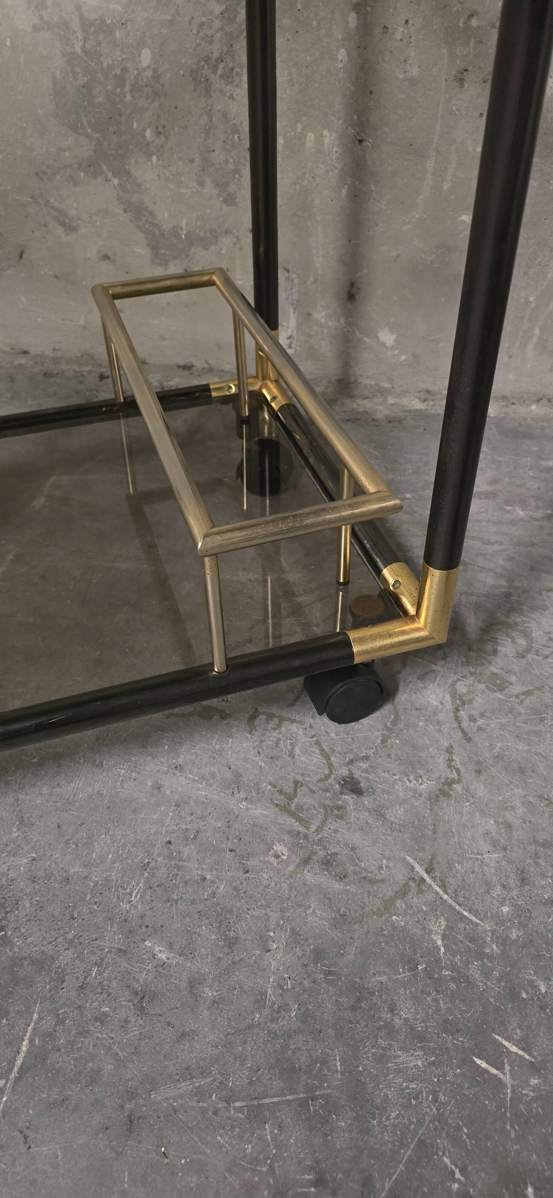 Black metal and brass rolling dessert trolley, smoked glass, 1970s.