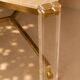 1970s dining table in travertine, gold metal and plexiglass.