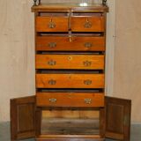Victorian high chest of drawers in walnut with a bronze gallery.