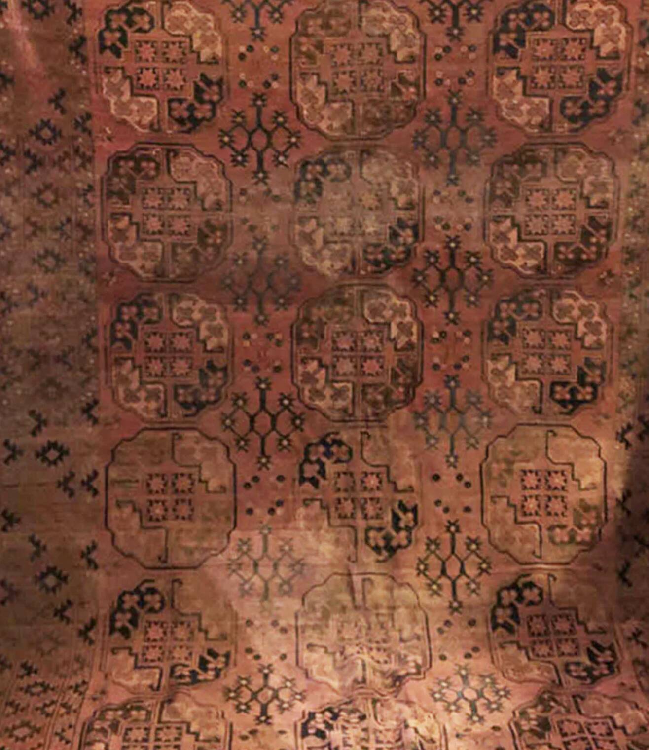 Antique Afghan/Turkmen wool rug, gul patterns, red and brown tones.