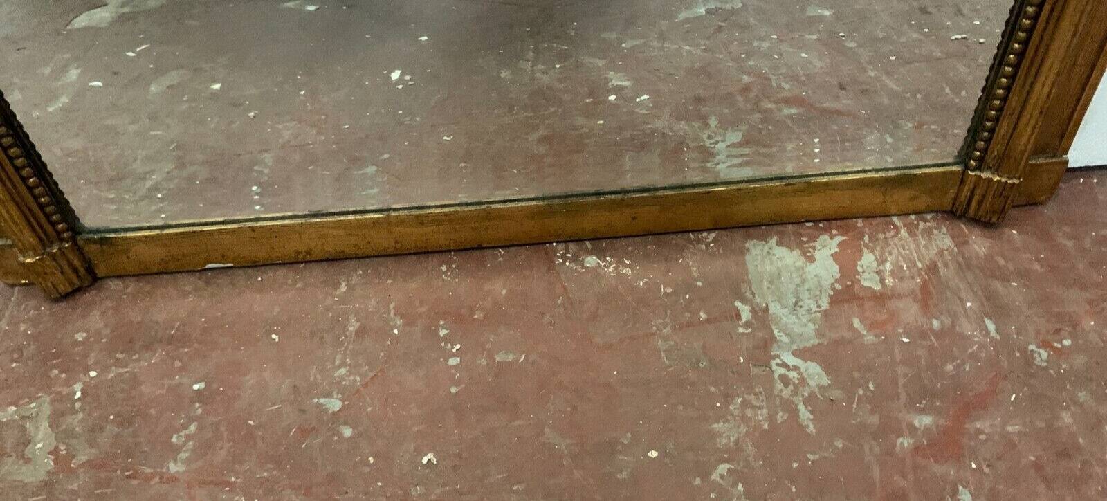 Louis XVI style mirror in wood and gilded stucco 20th century