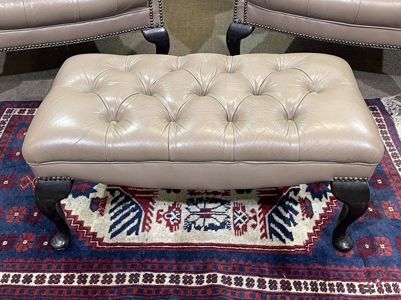 Pair of high-backed Chesterfield armchairs with 1 leather footrest