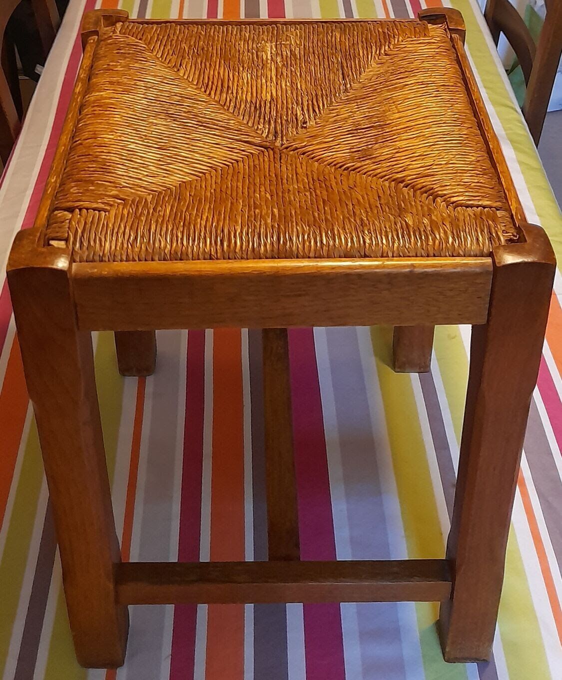 Oak stool seated in straw