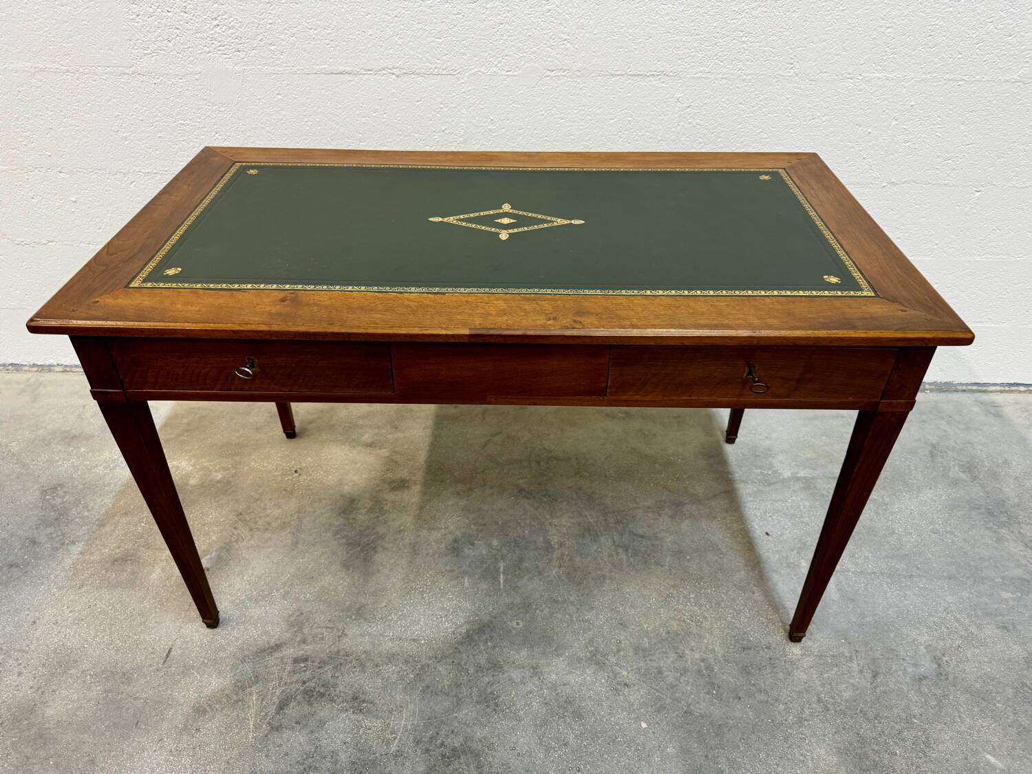 Louis XVI desk with green leather and shelves.
