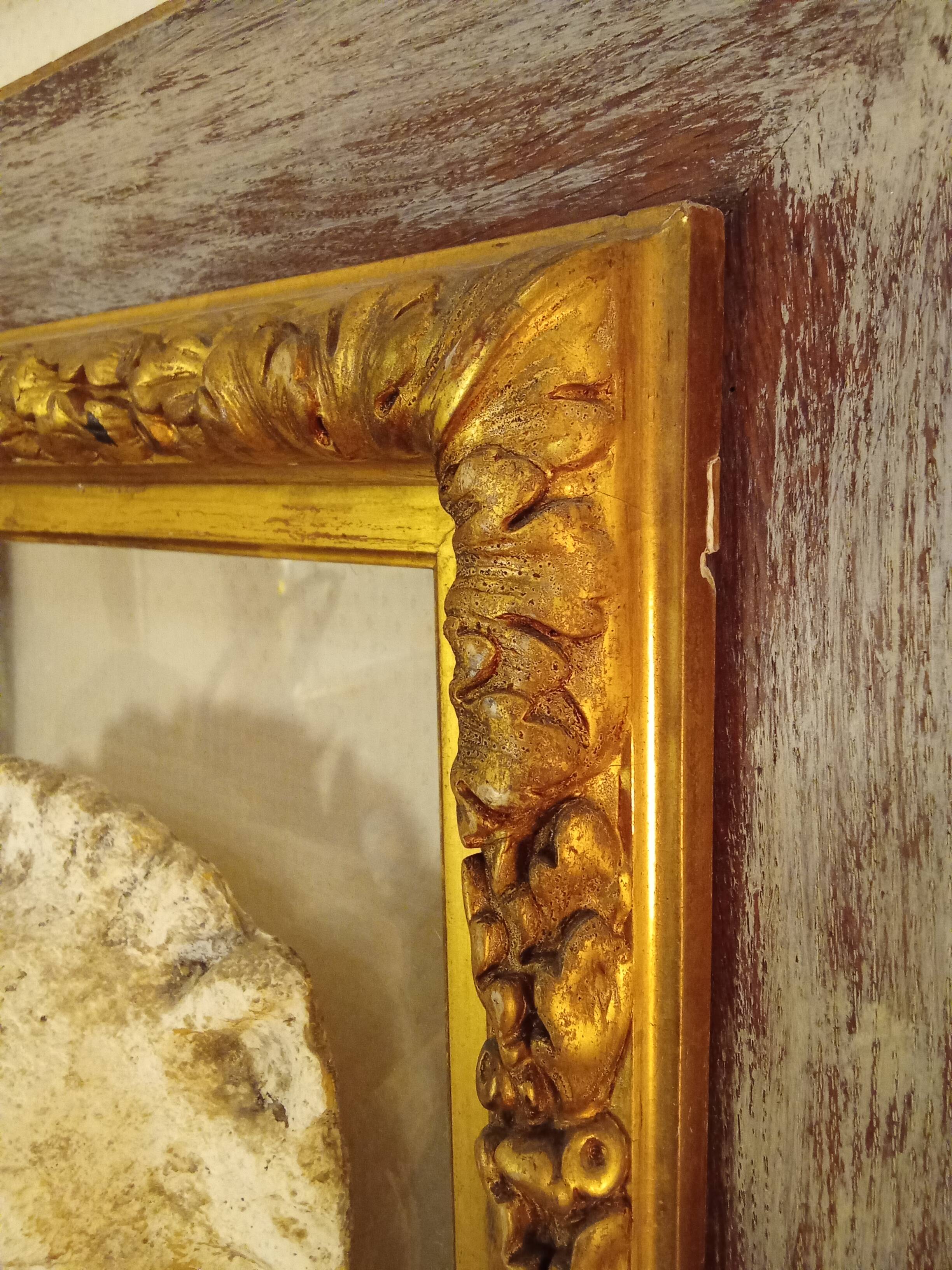 Antique gilded frame with stone lion head ornament on plexiglass