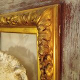 Antique gilded frame with stone lion head ornament on plexiglass
