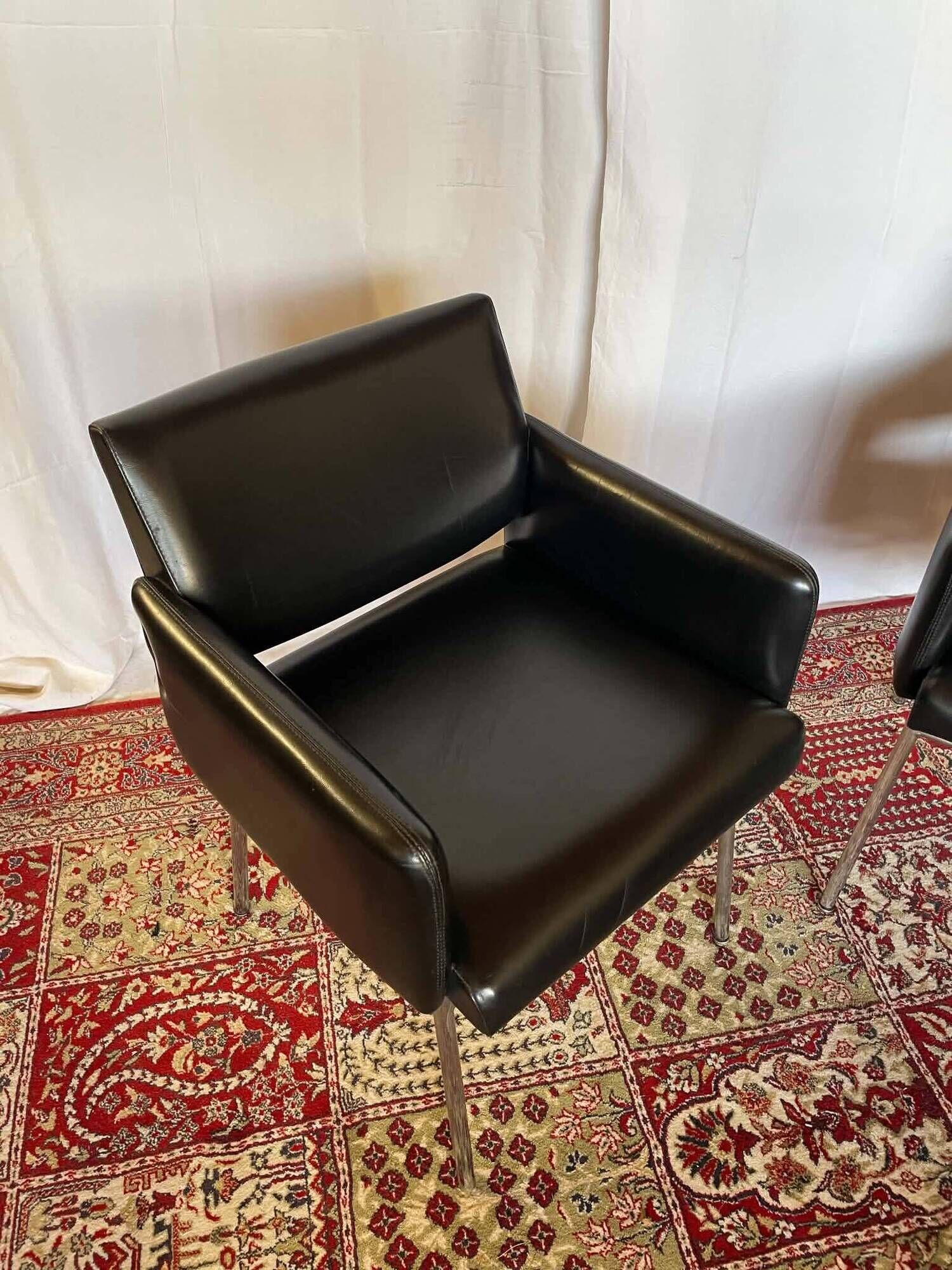 Pair of vintage armchairs in black faux leather and chrome metal.