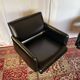 Pair of vintage armchairs in black faux leather and chrome metal.