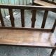 Duo of old solid oak benches with backs and armrests.
