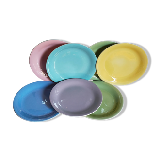 Seven pastel-colored plates mixed with vintage earthenware