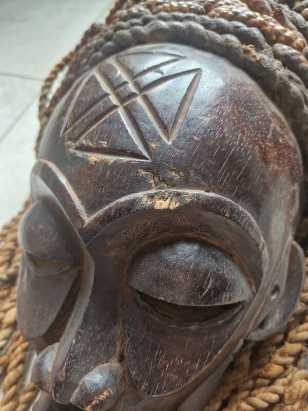 Chokwe Mwana Pwo mask in carved wood with a dark patina and rope hair