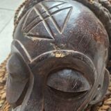Chokwe Mwana Pwo mask in carved wood with a dark patina and rope hair