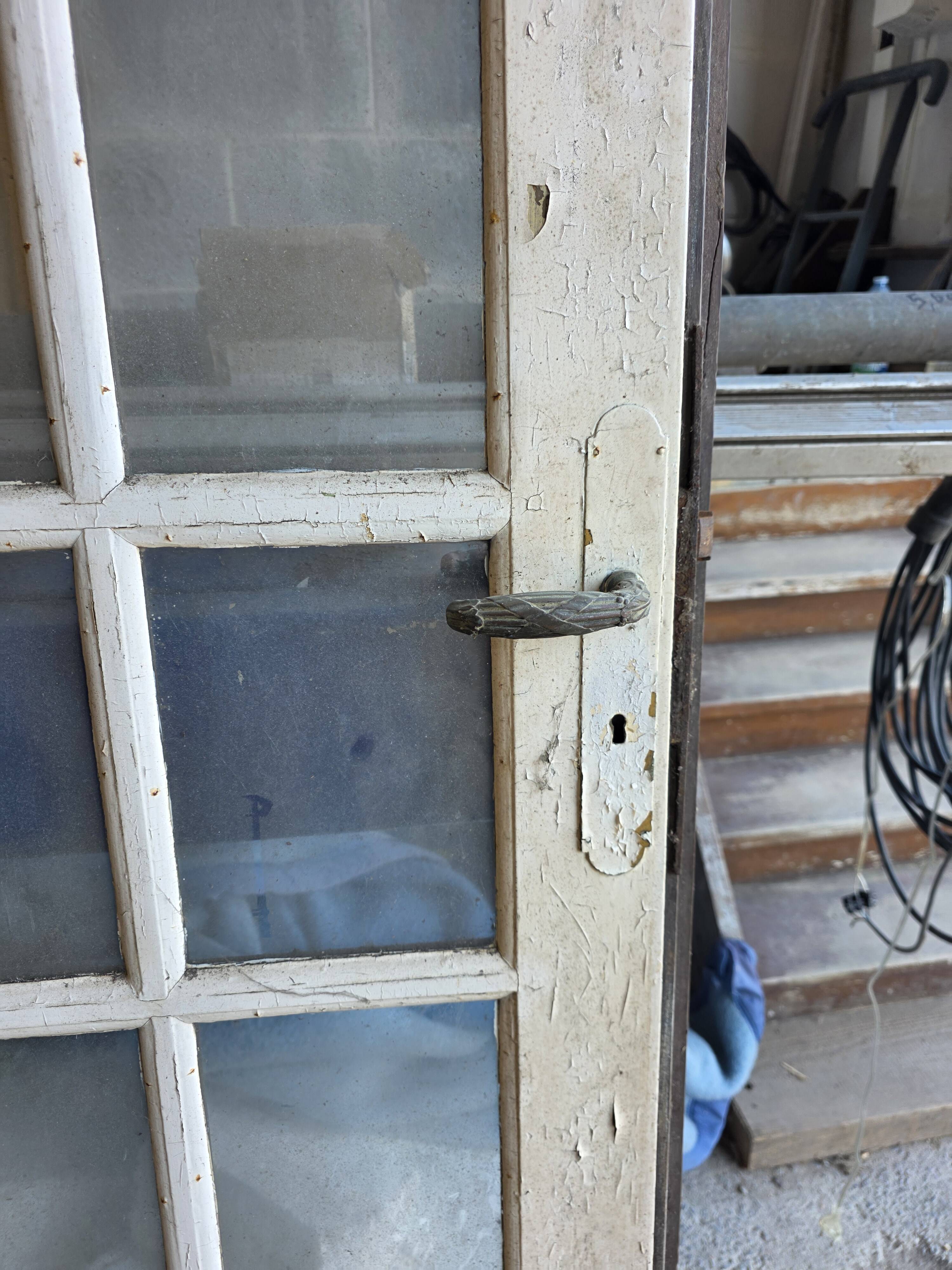 Two pairs of solid oak doors with small panes.