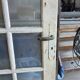 Two pairs of solid oak doors with small panes.