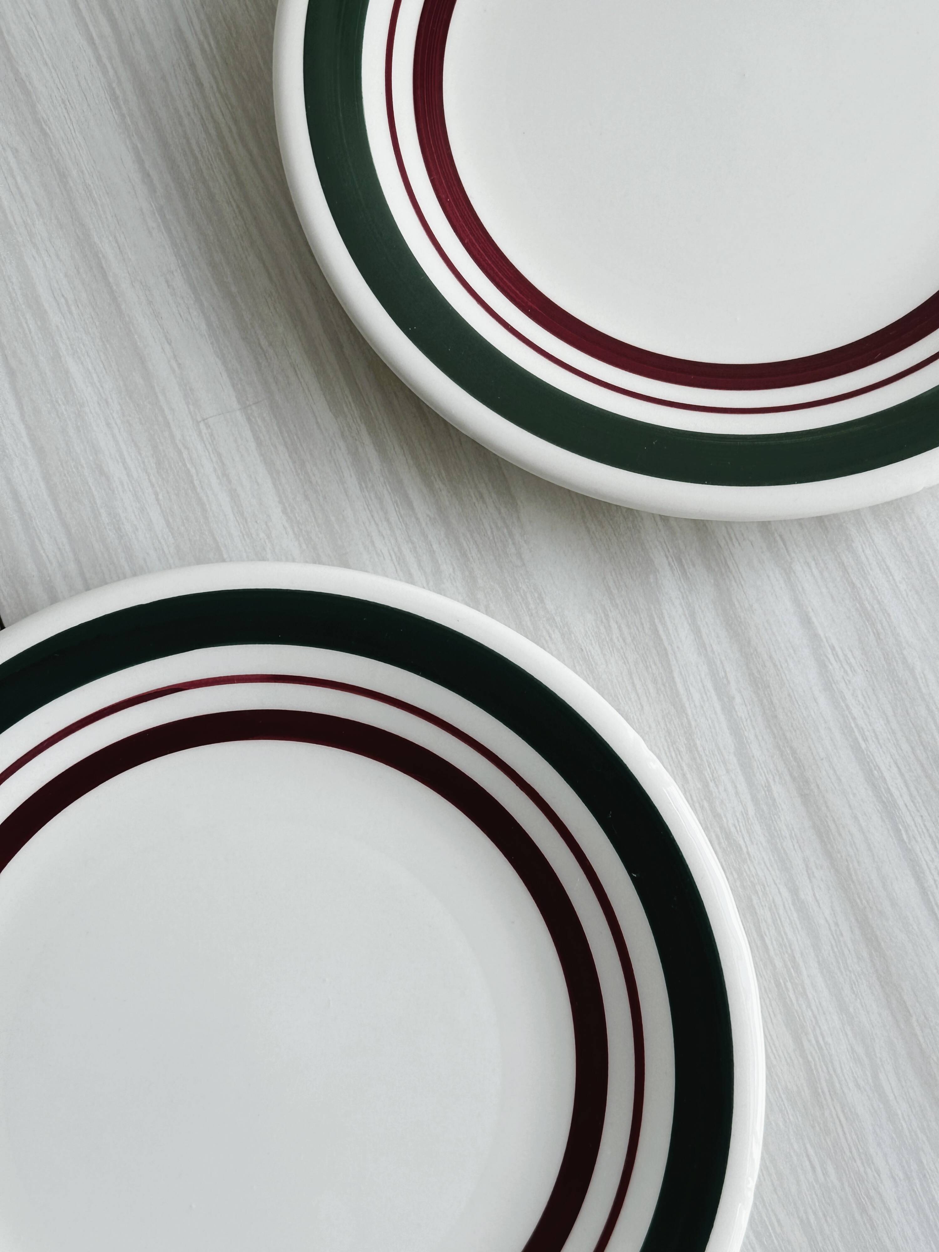 2 green and burgundy strip dessert plates.