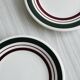2 green and burgundy strip dessert plates.