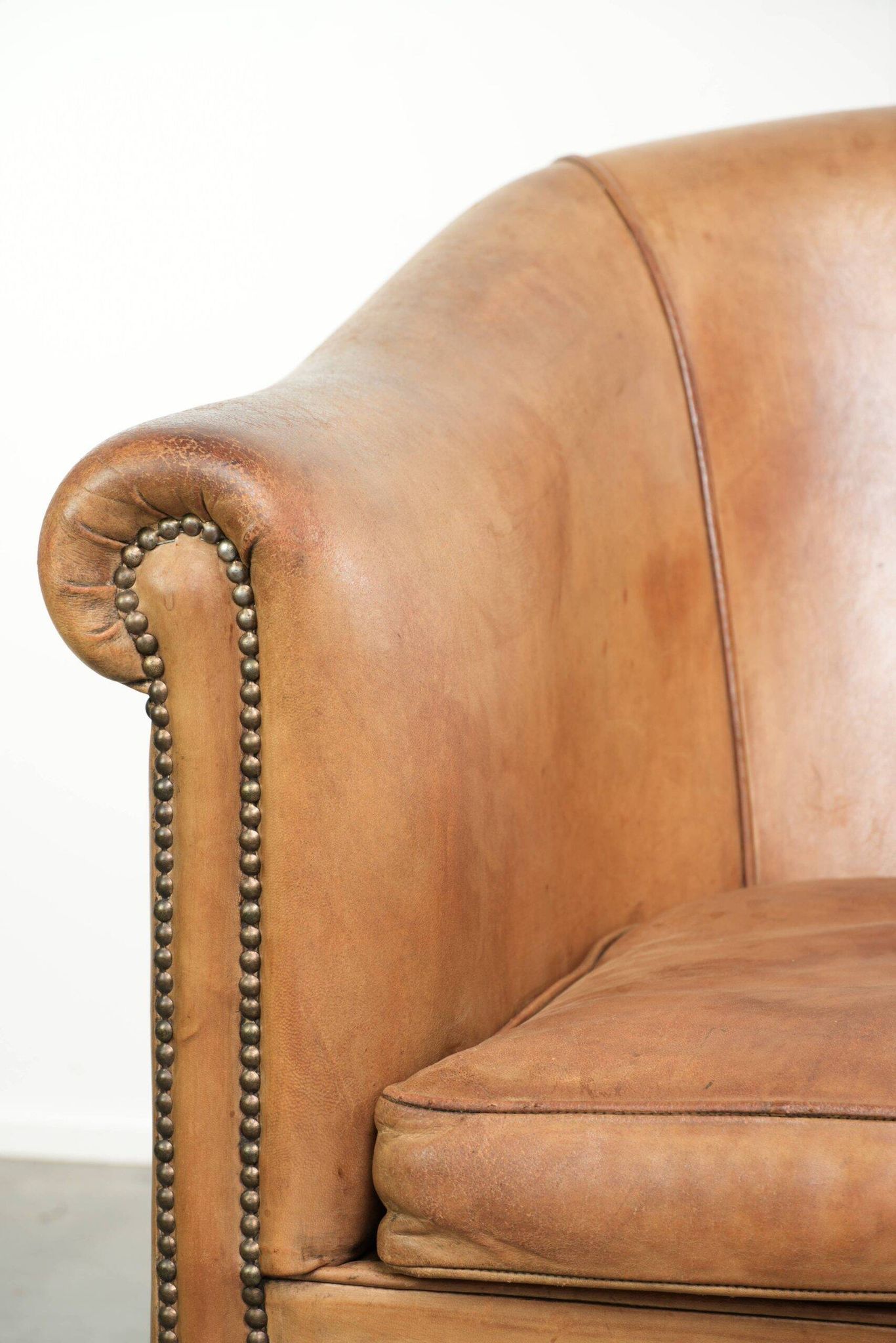 Comfortable sheepskin club armchair in a cognac colour