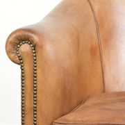 Comfortable sheepskin club armchair in a cognac colour