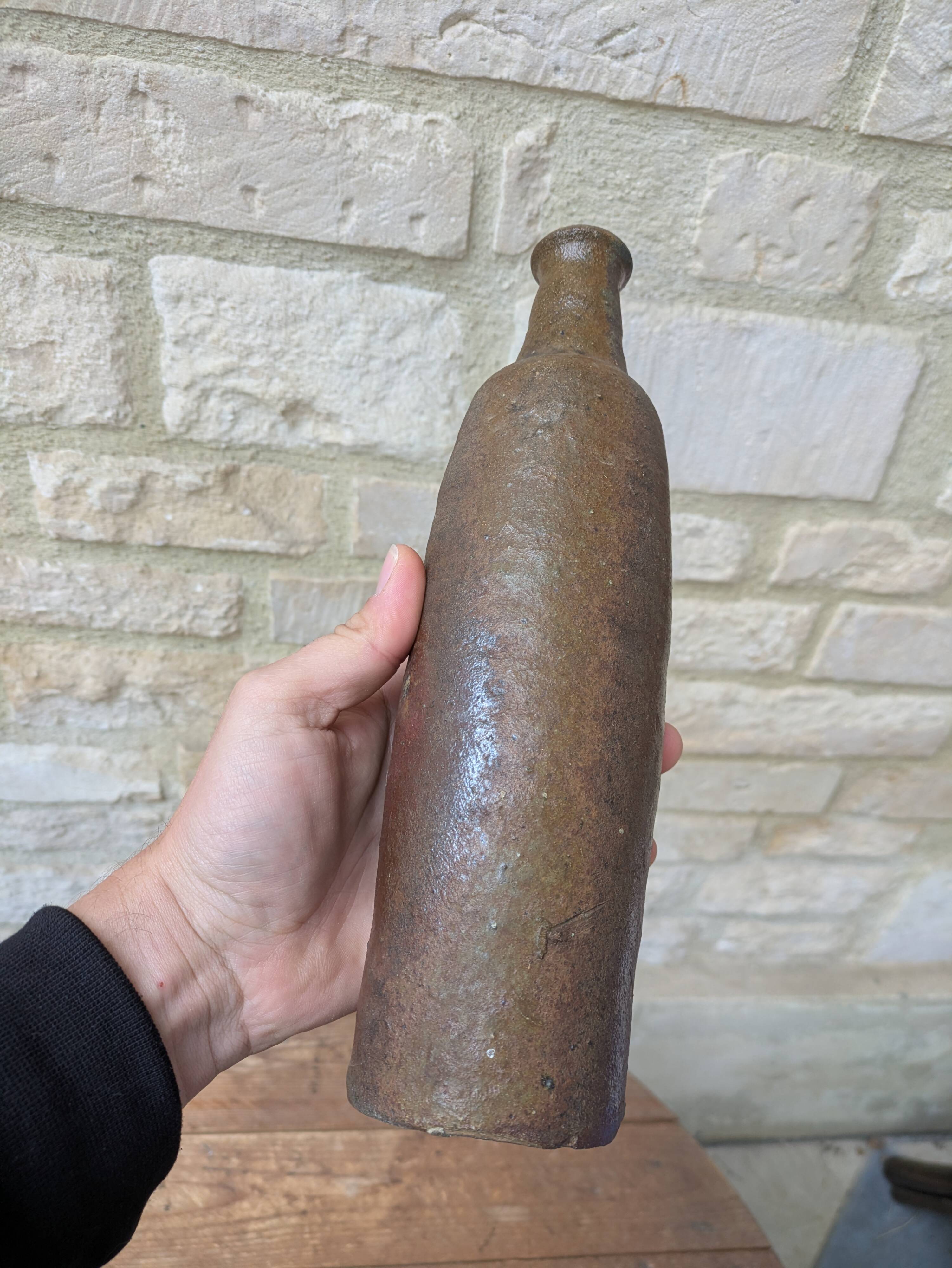 Old handmade terracotta bottle