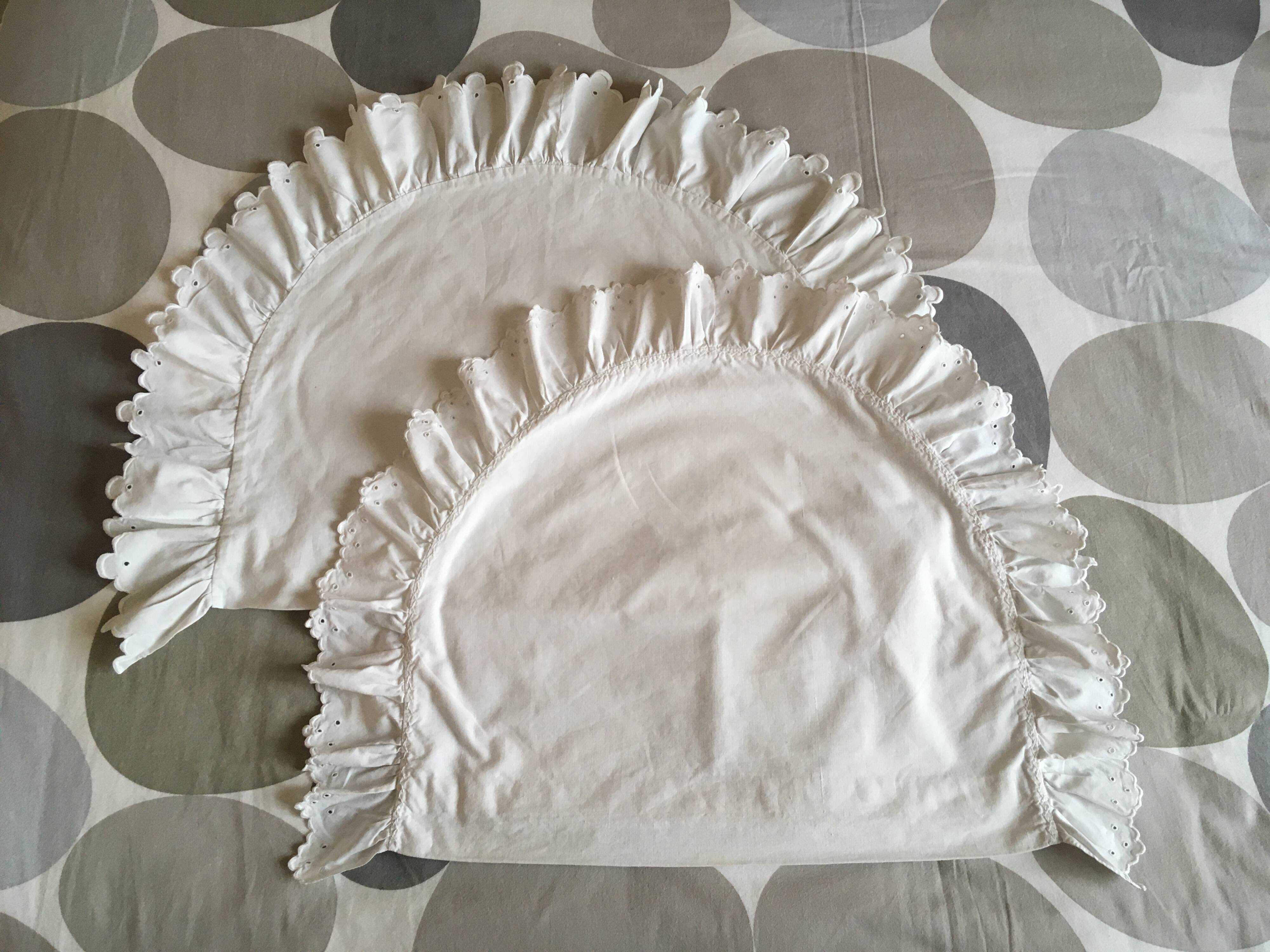 Two half-moon ruffled cushion covers