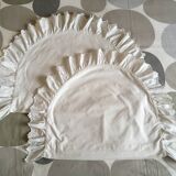 Two half-moon ruffled cushion covers