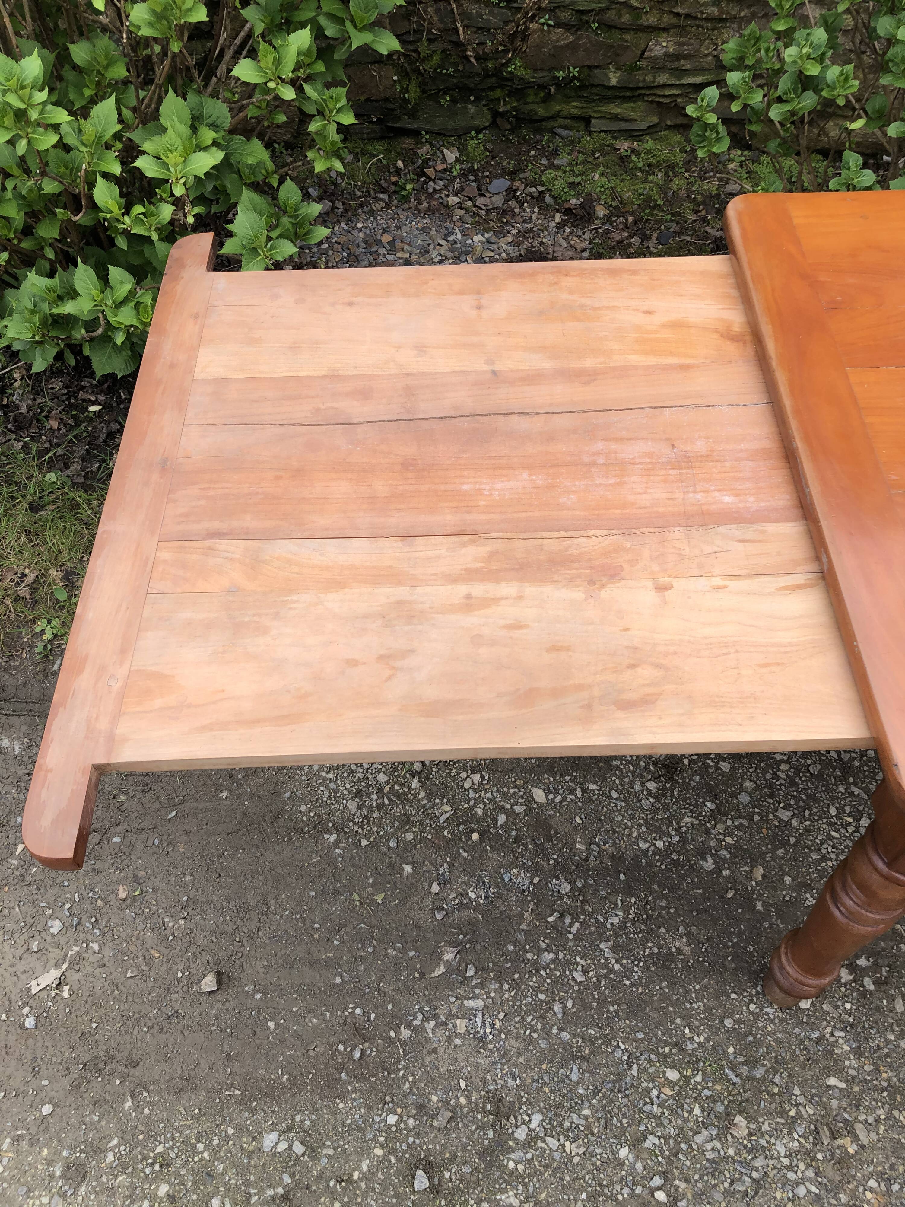 Antique Louis Philippe style farmhouse table in solid cherry wood with its 2 extensions.