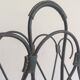 Magazine rack in leather and black lacquered metal. Attributed to Jacques Adnet