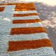 Handmade orange and white wool rug, traditionally crafted, size 140 x 260 cm