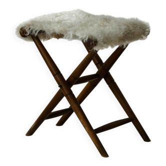 Folding stool, reupholstered in long-haired sheepskin, mid-century modern style, 1950s.