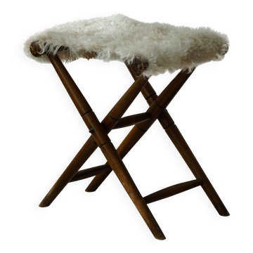 Folding stool, reupholstered in long-haired sheepskin, mid-century modern style, 1950s.