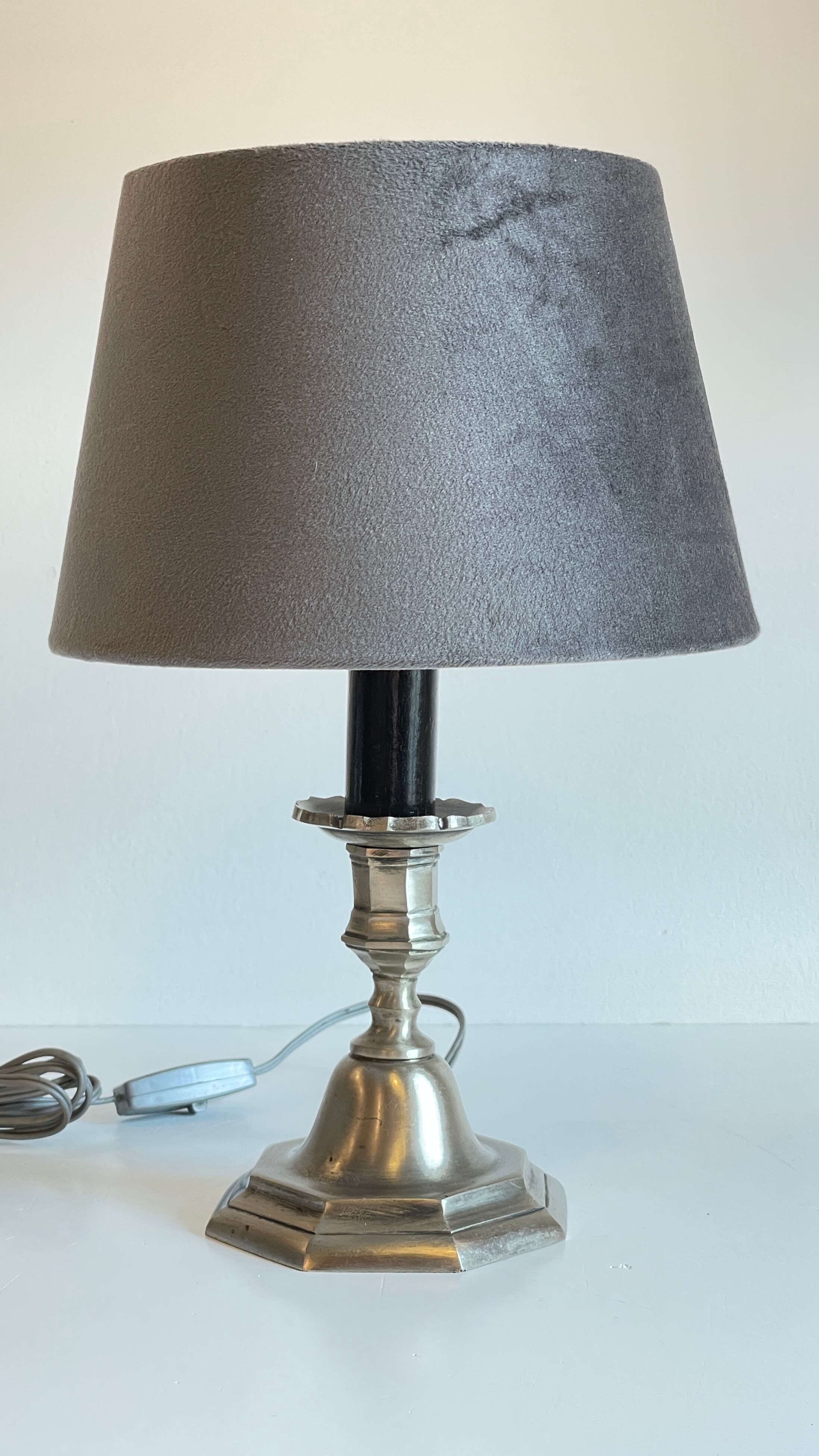 Steel candlestick lamp and grey velvet