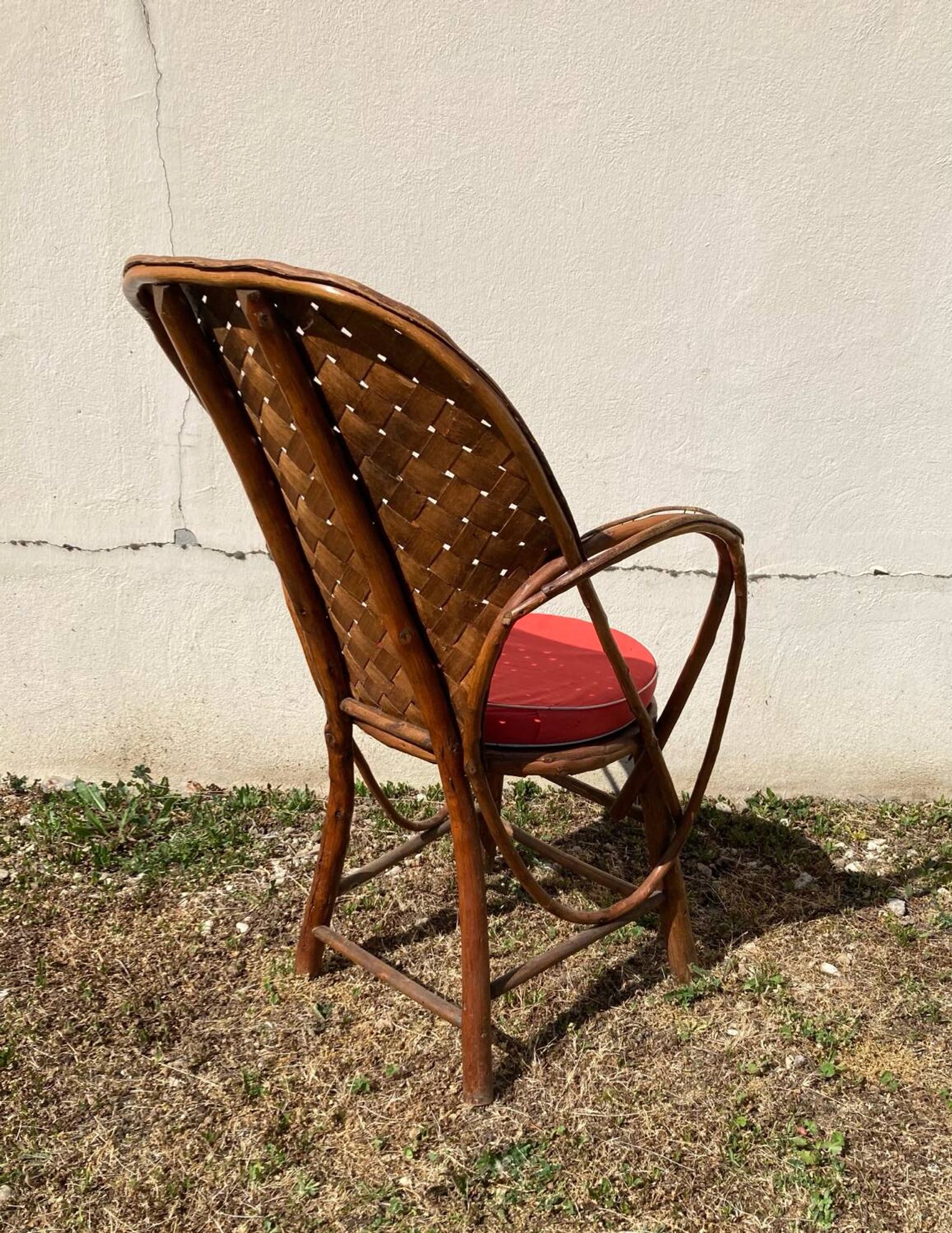 Vintage 1970s armchair in curved woven chestnut + seat cushion